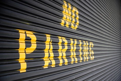 No parking - yellow sign on the garage