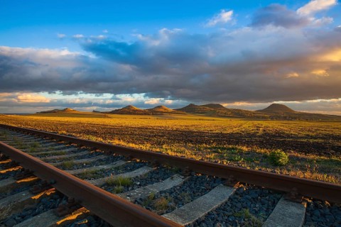 Single railway track at sunset, Central Bohemian Uplands, Czech Republic. Railway track in nature