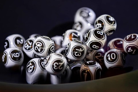 Black and white lottery balls in a bingo machine. Lottery balls in a sphere in motion. Gambling