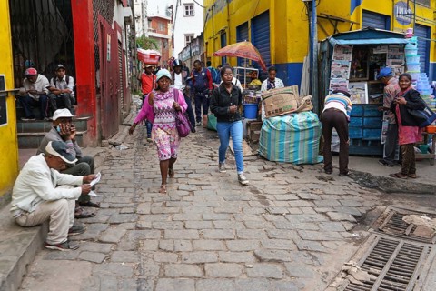 Antananarivo, Madagascar - April 24, 2019: Two unknown young Malagasy girls walking cobblestone