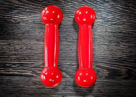 Red dumbbells on vintage wooden board