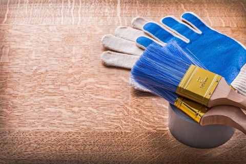 Paint brushes on duct tape and protective gloves construction concept