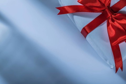 Wrapped red present box on white background