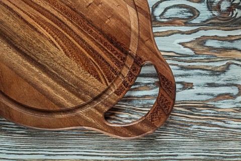 Round chopping board on wooden surface