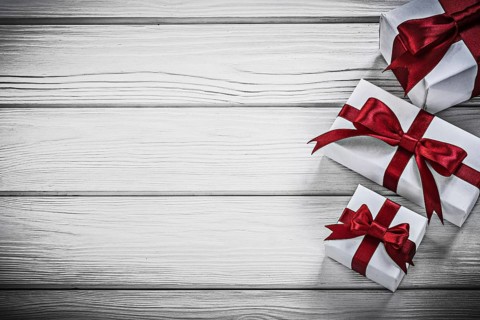 White present boxes on wooden board copyspace holidays concept