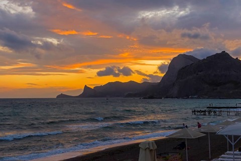 Sunset in the bay of the resort town of Sudak. Crimea