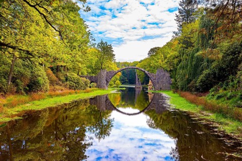 The Devil's Bridge on the Rakots River. Park Kromlau, Germany. The basalt columns of the bridge