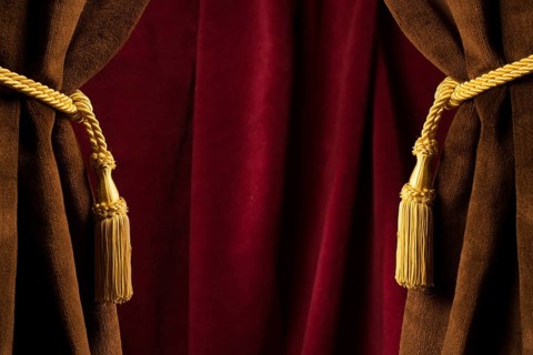 Red theatre curtains and yellow tassels