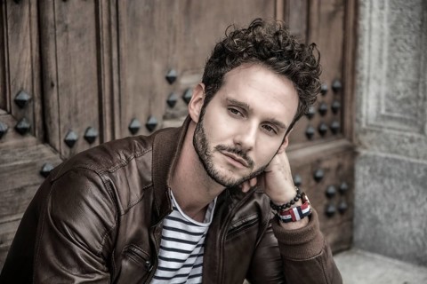 Attractive young man outdoor wearing leather jacket, in European city, Turin in Italy