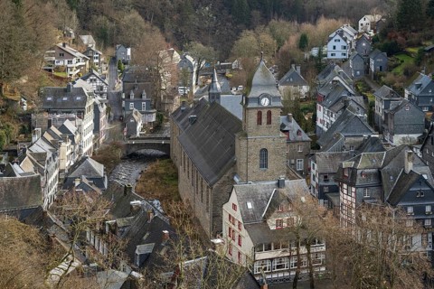City Monschau in Region national park Eifel in winter with river and church
