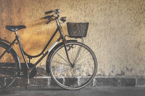 Vintage bicycle leaning against a wall. Retro style photo