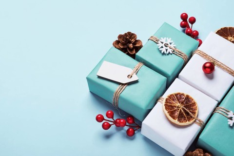 Gifts boxes set packed in paper, decorated with baubles and twine. Eco Christmas decor