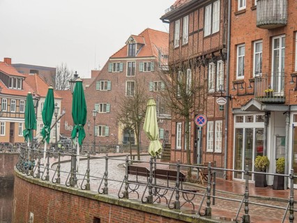 Street scene with brick buildings and closed green sunshades in a quiet atmosphere, stade, germany