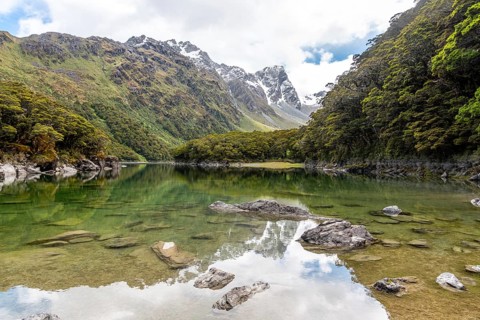 Tranquil mountain lake Mackenzie at the famous Routeburn Track, Fiordland National Park, South