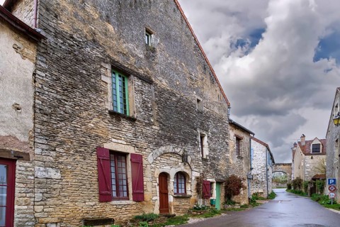 Street in Chateauneuf commune with historical stone houses, France