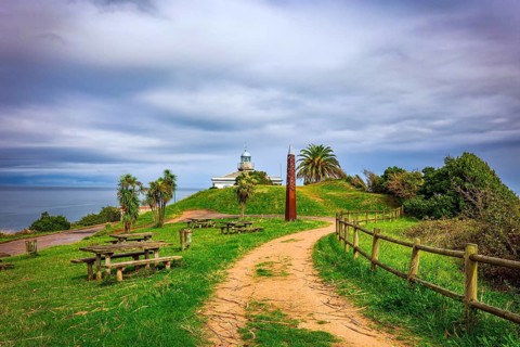 The road to the lighthouse. The picturesque seaside fishing town of Candas. Atlantic coast, Spain.