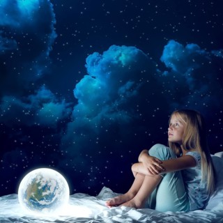 Cute girl sitting in bed and looking at Earth planet. Elements of this image are furnished by NASA