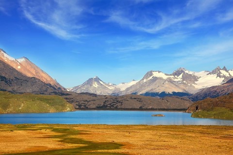 A blue lake in a picturesque valley surrounded by snow-capped mountains. National Park Perito