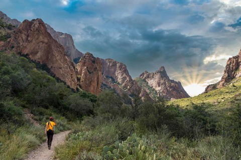 A hiker walking thtough the mountains of Big Bend National Park, USA