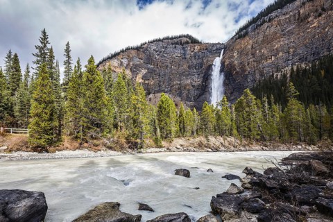 Colossal Takakkaw waterfall formed by melting glacier Daly. Autumn day in Yoho National Park in the