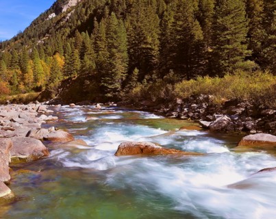 Pastoral in the Alpine mountain valley in Austria. Rapid mountain stream. Cascades of cold water at