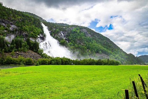 Norway. Huge powerful cascading waterfal Vidfossen. Scenic road in the mountains of Western Norway.