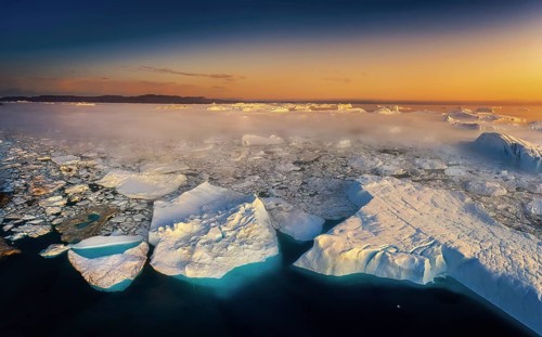 Floating glaciers in the rays of the setting sun during a polar night