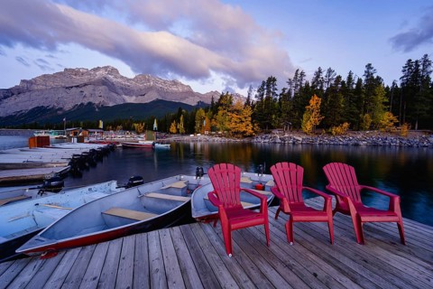 Beautiful autumn landscape scene in lake and mountain in background in west Canada, colour kayaks