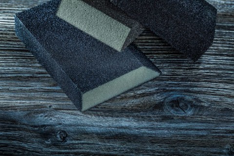 Sanding sponges on vintage wooden board top view