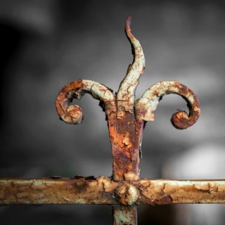 Forging railing to shape flame, vintage detail. Shallow depth of field. Defocused blurry background