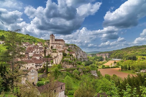 View of Saint-Cirq-Lapopie village with catholic church, France