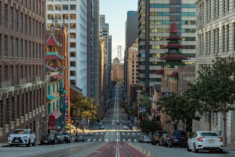 A picture of the long California Street, with Downtown San Francisco and the Oakland Bay Bridge at