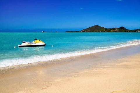 Jolly Beach a beach in Antigua in the Caribbean with azure blue sea and a jet ski