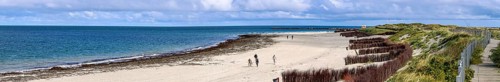 Panoramic photo north beach Helgoland dune with tourist hiker and wooden dune path, island