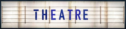 A Grungy Old Weathered Theatre Marquee Sign With Blue Letters