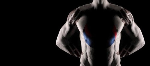 South Korea flag on muscled male torso with abs, black background