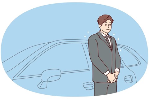 Car driver in suit standing near car waiting for client. Chauffeur in formalwear working in luxury