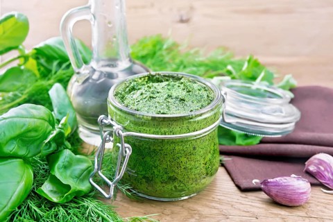 Sauce of dill, parsley, basil, cilantro, other spicy herbs, garlic and vegetable oil in a glass