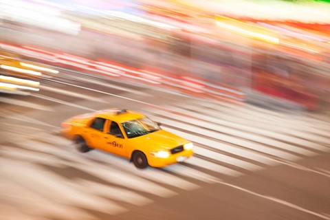 Panning image of a Yellow Taxi cab in Times Square, New York City. New York. USA