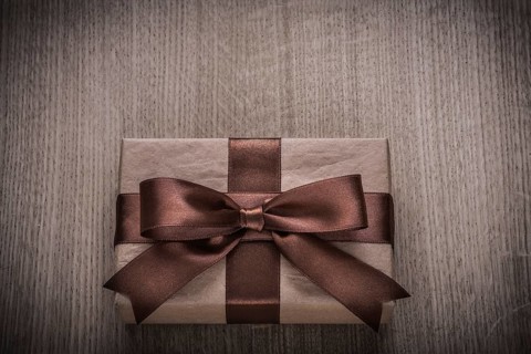 Wrapped vintage present box with tied brown bow celebration concept