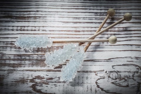 Sweet sugar sticks on vintage wooden board