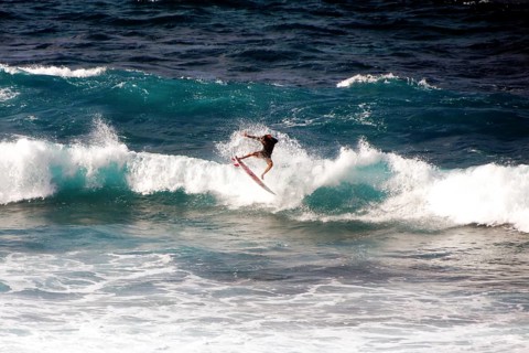 Surfer riding a wave in Hookipa Beach, Maui, Hawaii