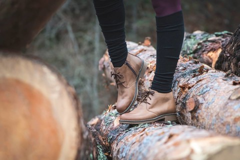 Womens leather casual shoes on wood in the forest