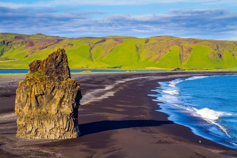 Cape Dyrholaey. Travel to the fabulous island of Iceland. Giant lonely rock - Palm on a black