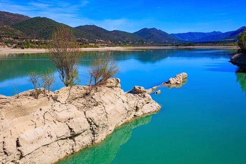Picturesque backwater. Wonderful autumn day. The La Penia Reservoir collects the waters of the