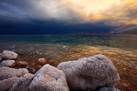 Coast of the Dead Sea in Israel in a spring thunder-storm. The coastal stones covered by salty