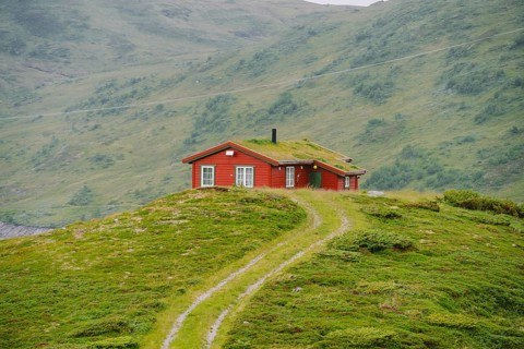 Hut wooden mountain huts in mountain pass Norway. Norwegian landscape with typical scandinavian