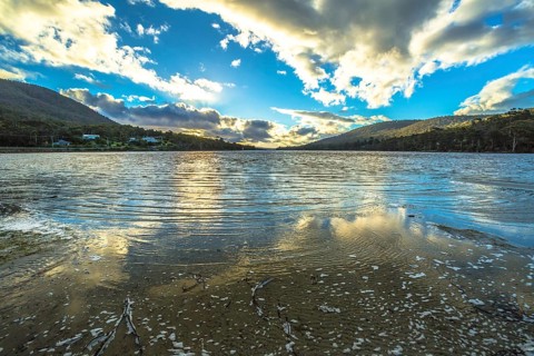 Wild landscapes with clouds reflected in the water, in Tasman Peninsula in South Eastern Tasmania,