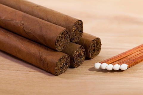 Different cigars on wooden table