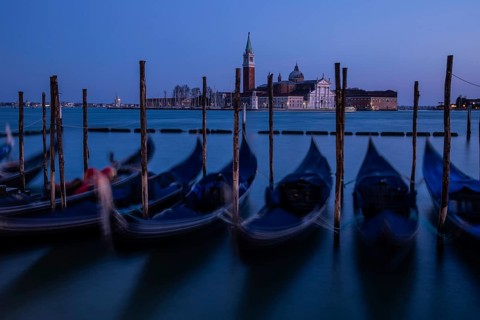 Venetian gondolas, boat dock at St Mark's Square, church of San Giorgio Maggiore in the background,